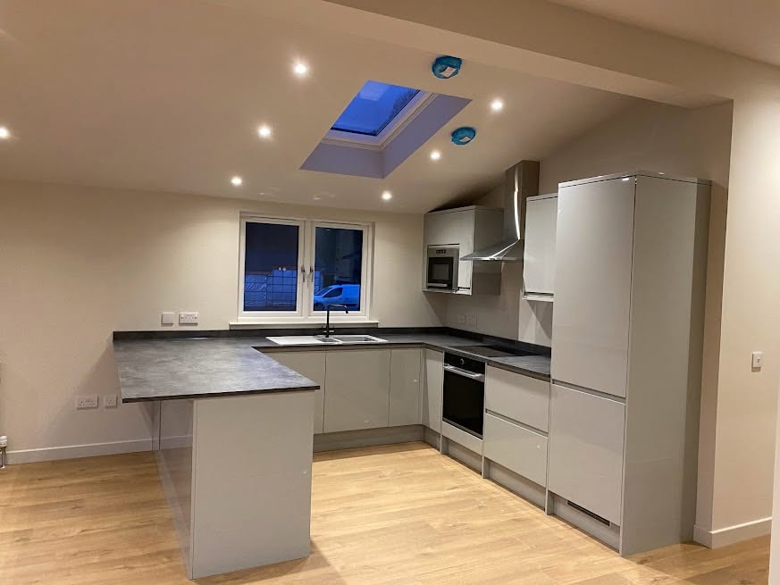Finished kitchen with recessed ceiling lights, rooflight and fitted appliances