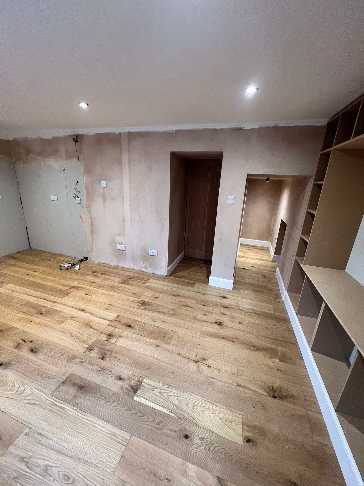 Renovated interior with oak flooring and built-in shelving