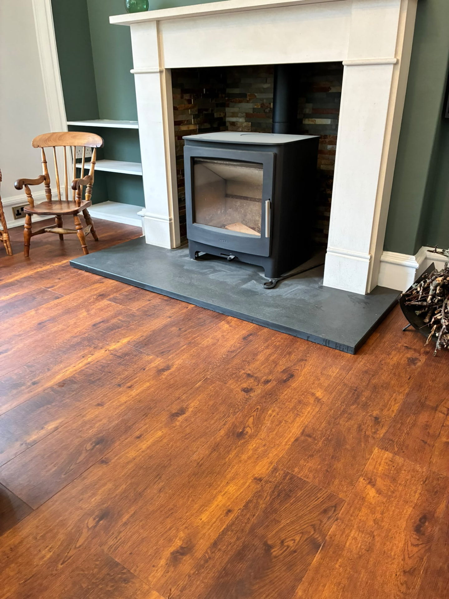 Supplied interior photograph showing a fireplace and finished room