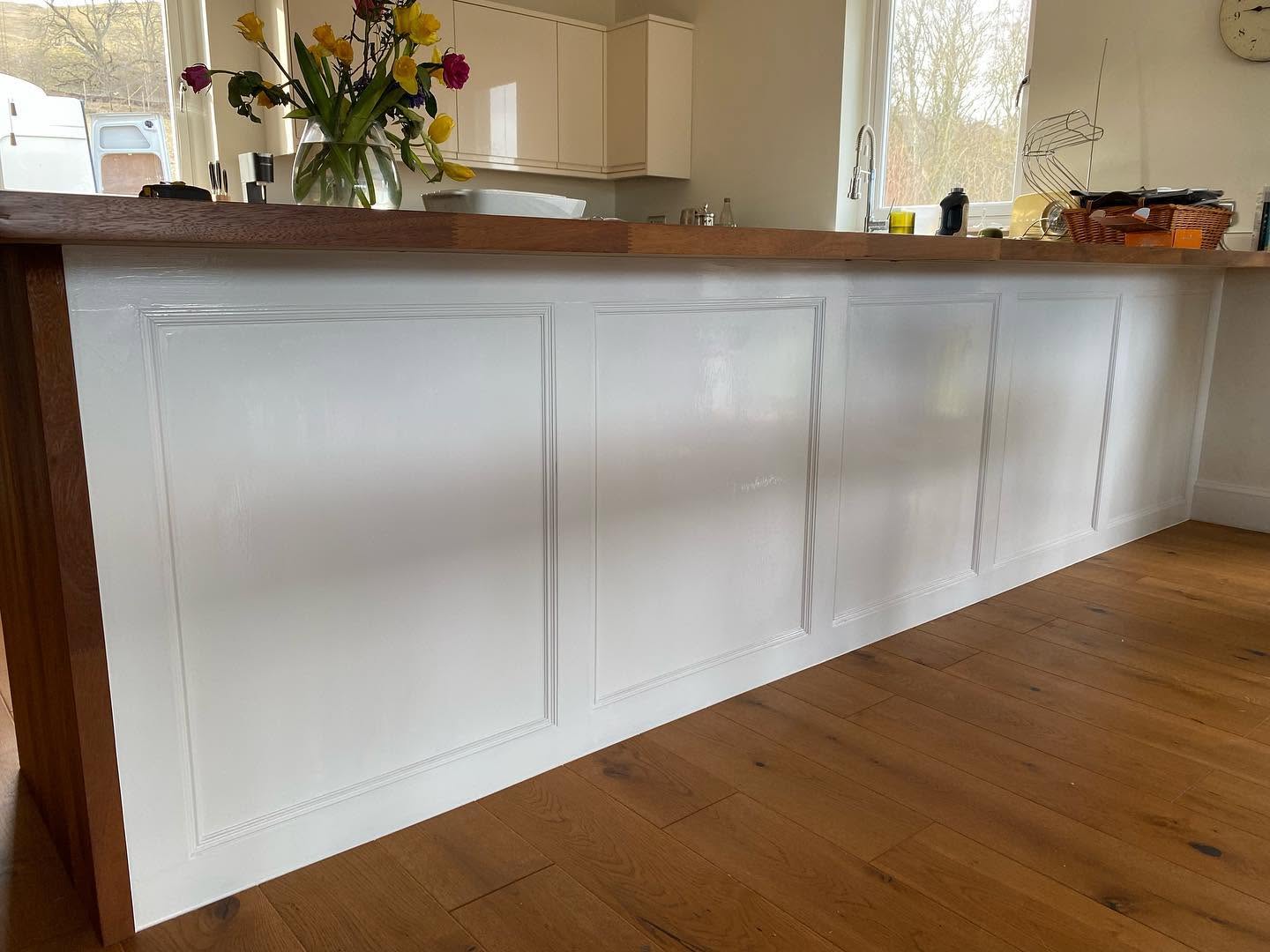 Finished white wall panelling beside timber flooring