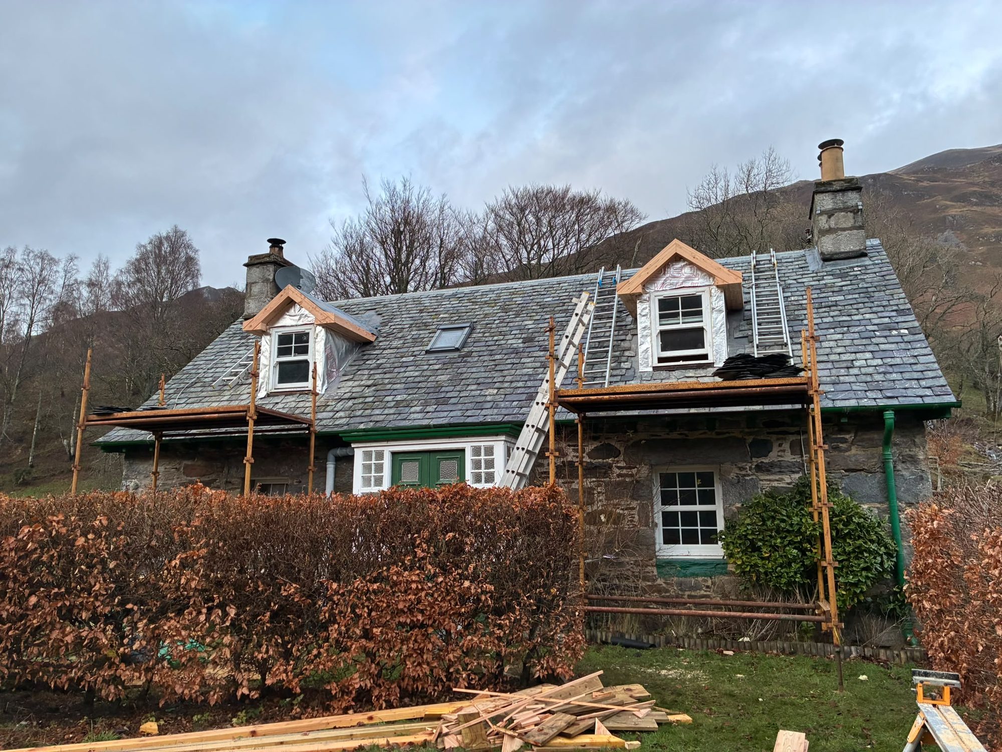 Stone cottage slate re-roofing with new dormer windows under construction