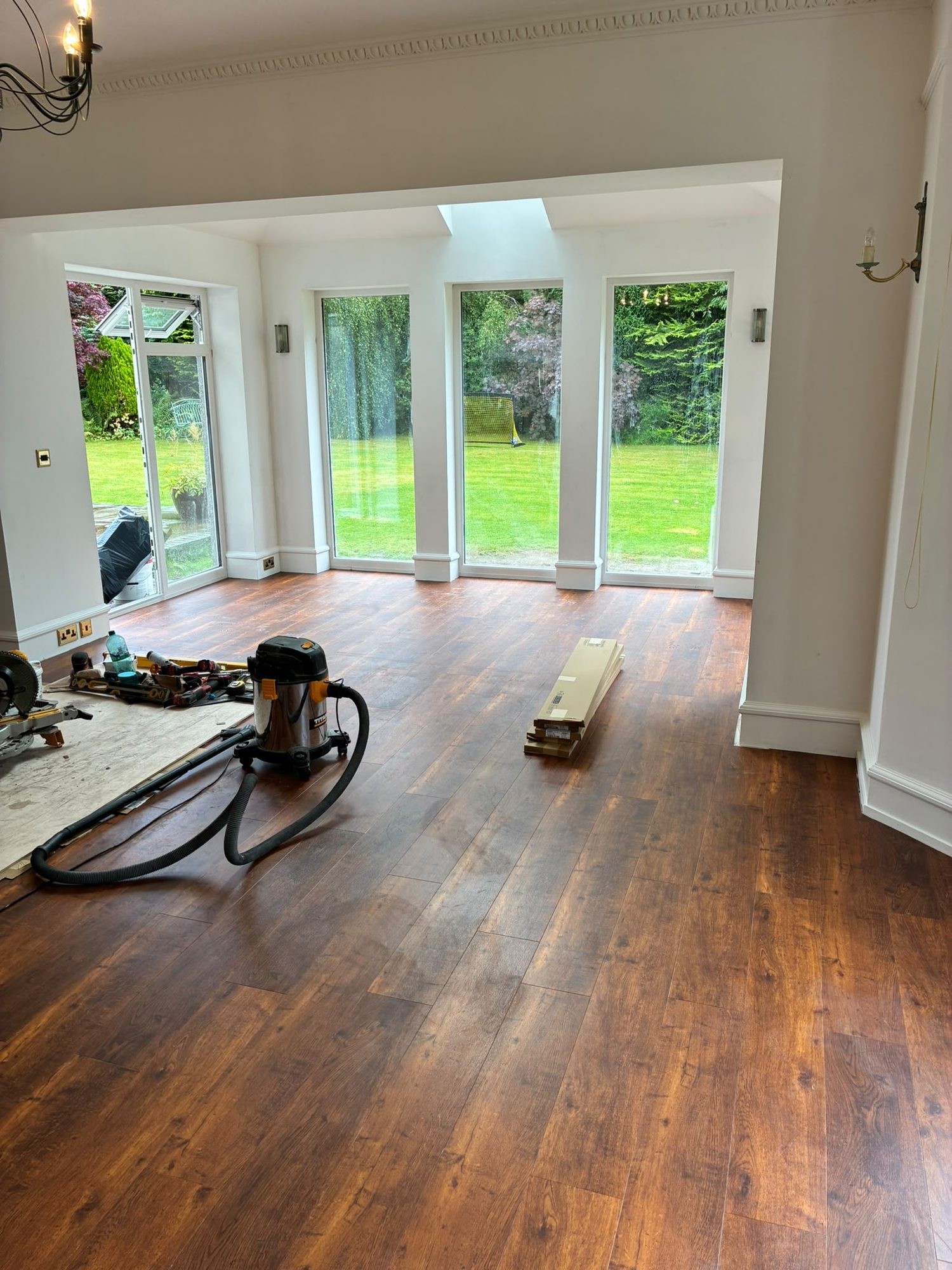 Hardwood flooring being installed in a new house extension