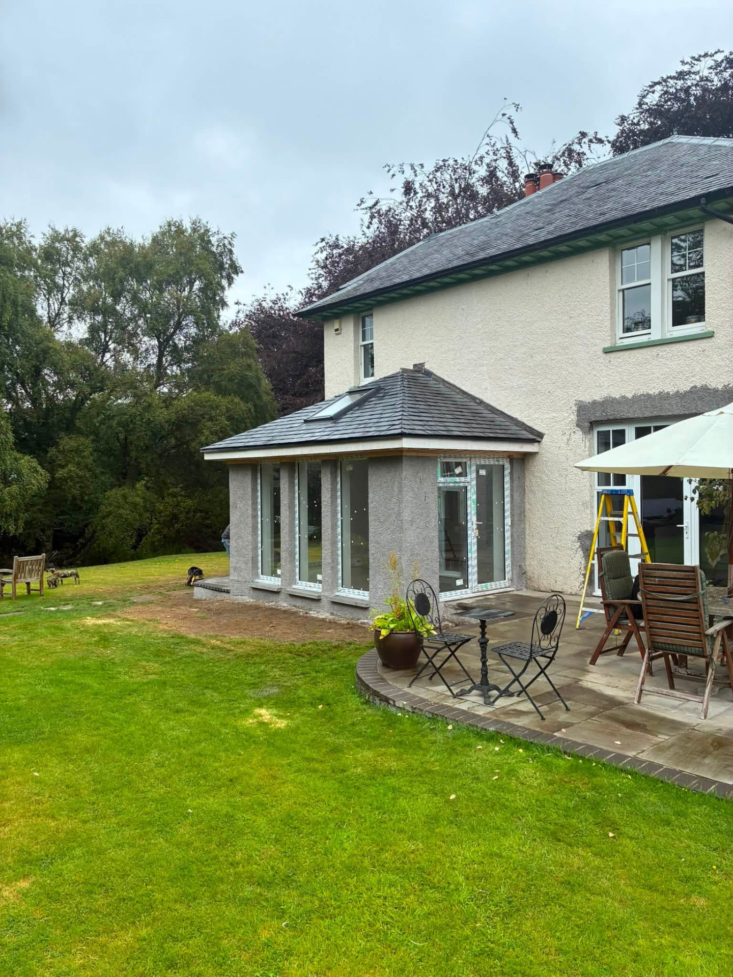 Glazed house extension overlooking a lawn and patio