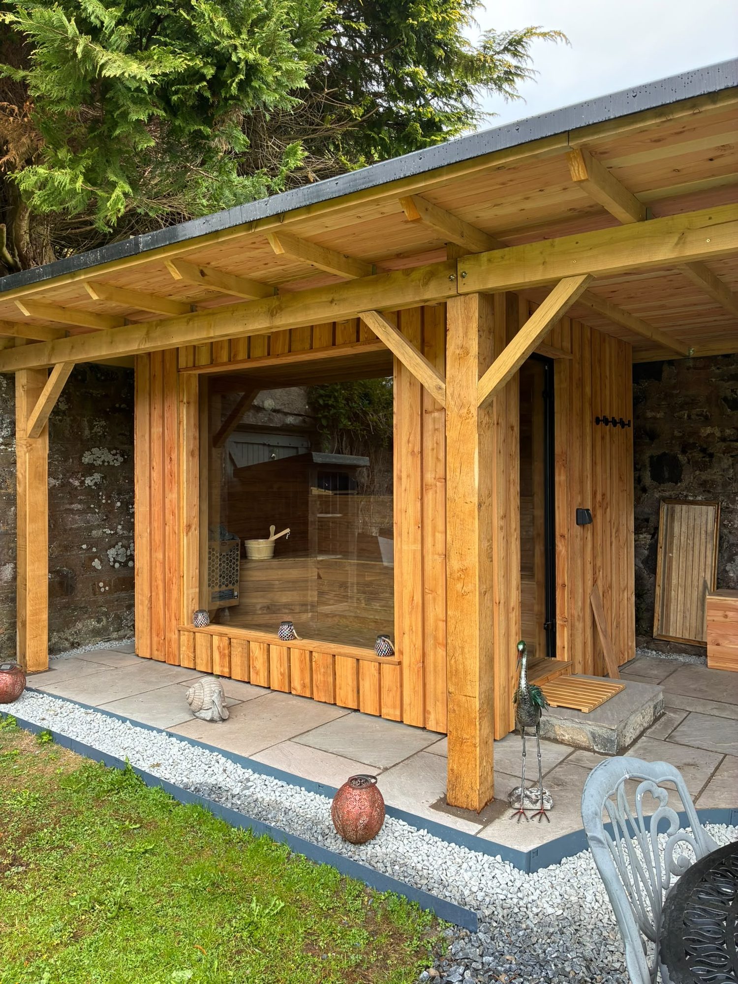 Timber-frame garden sauna building with larch cladding