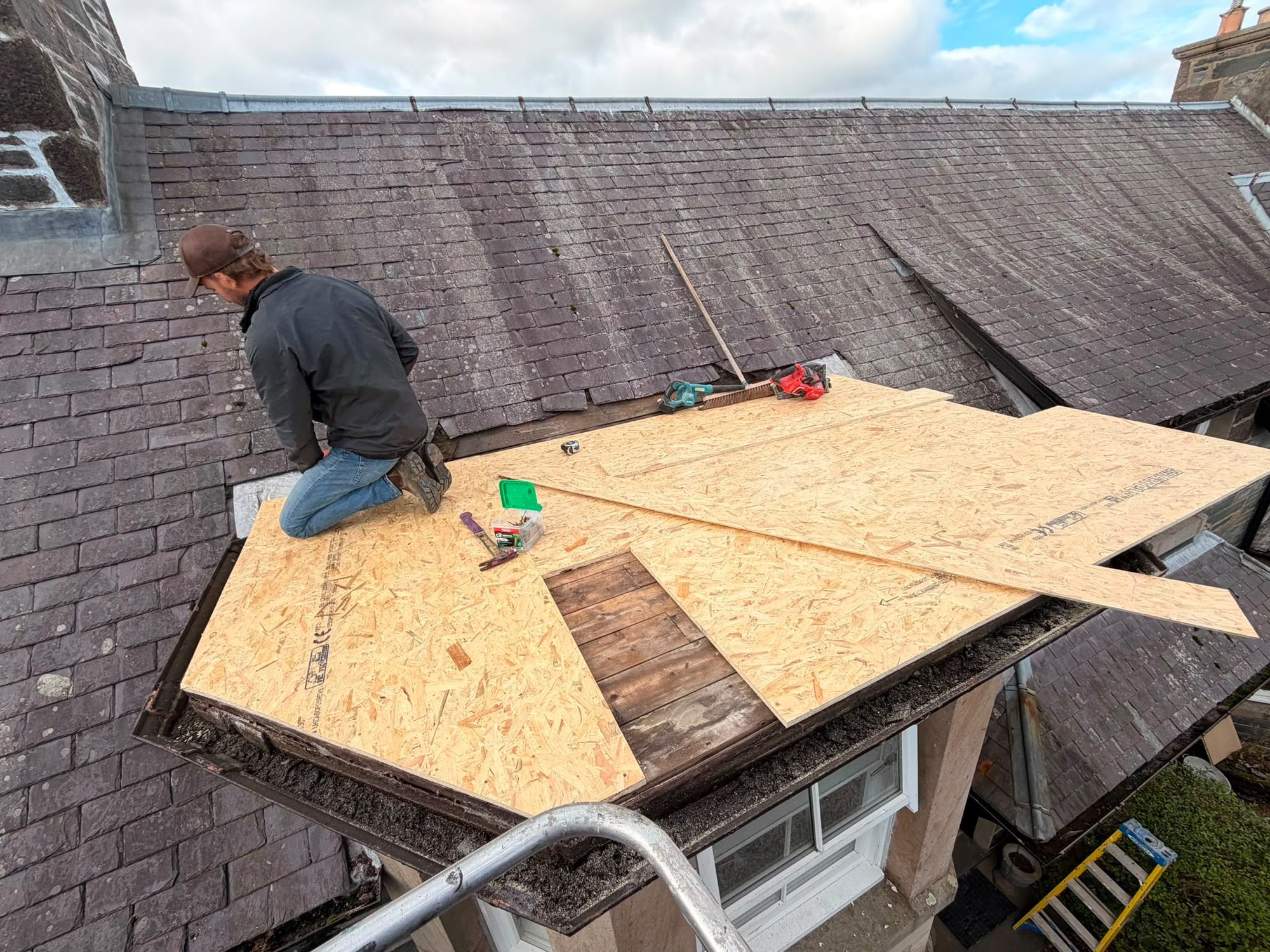 Flat roof repair with new OSB decking over a bay window