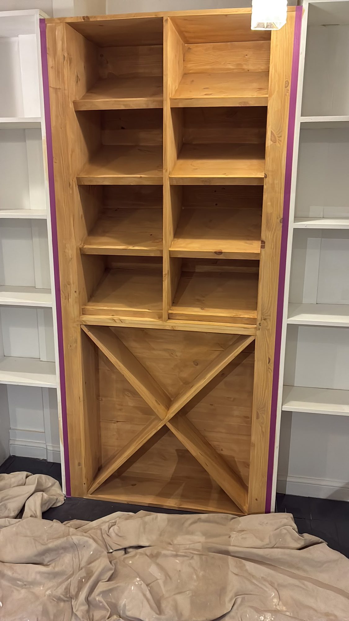 Bespoke timber wine rack and shelving unit made by our joiners