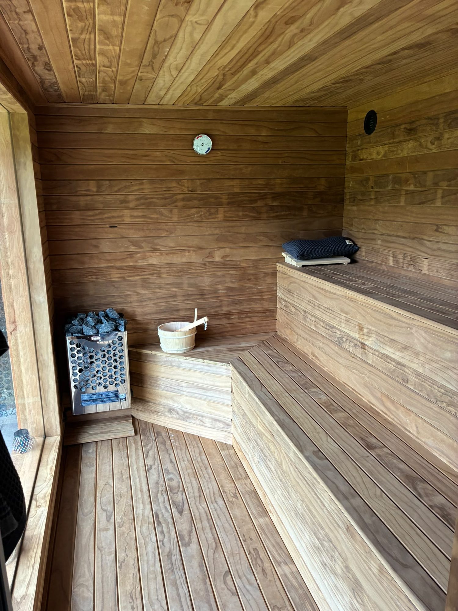 Bespoke timber-lined sauna interior with benches