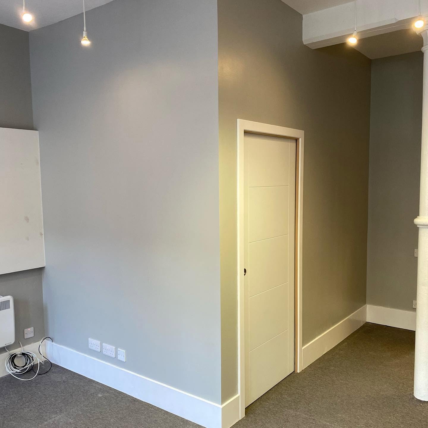 Finished partition wall and doorway in a carpeted room