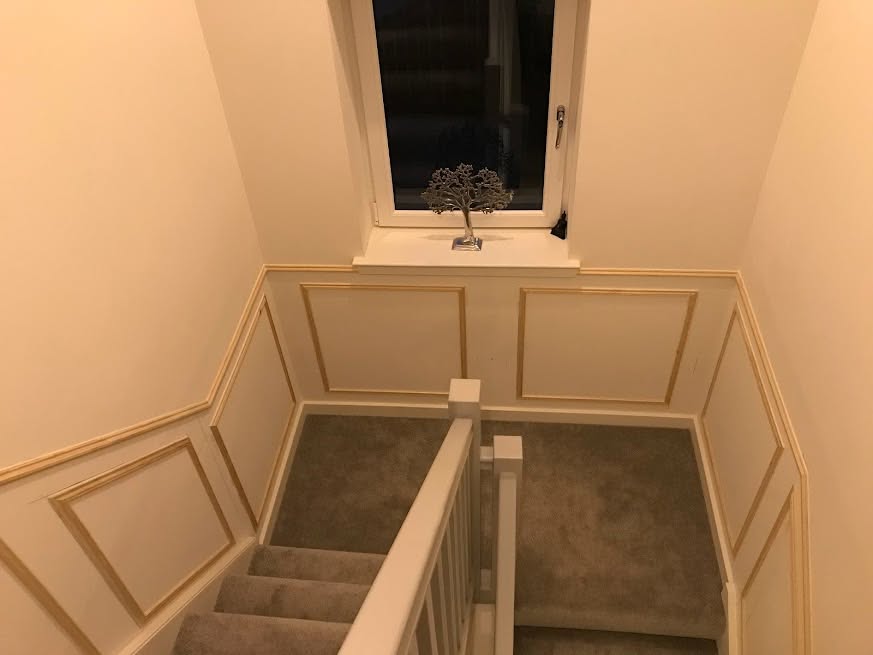 Staircase landing with decorative wall panelling during work